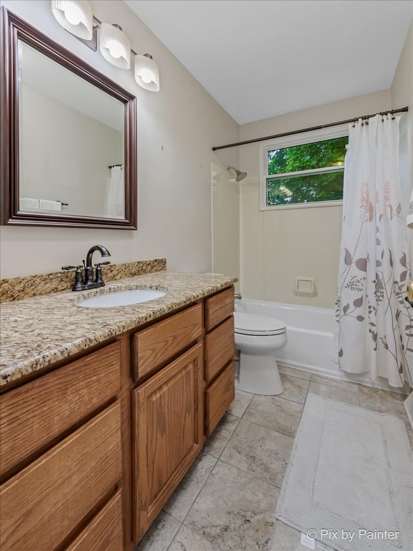 2302 Birch Lane Rolling Meadows, IL 60008 - Photo 5 of 30 a bathroom with a granite countertop sink mirror and a toilet