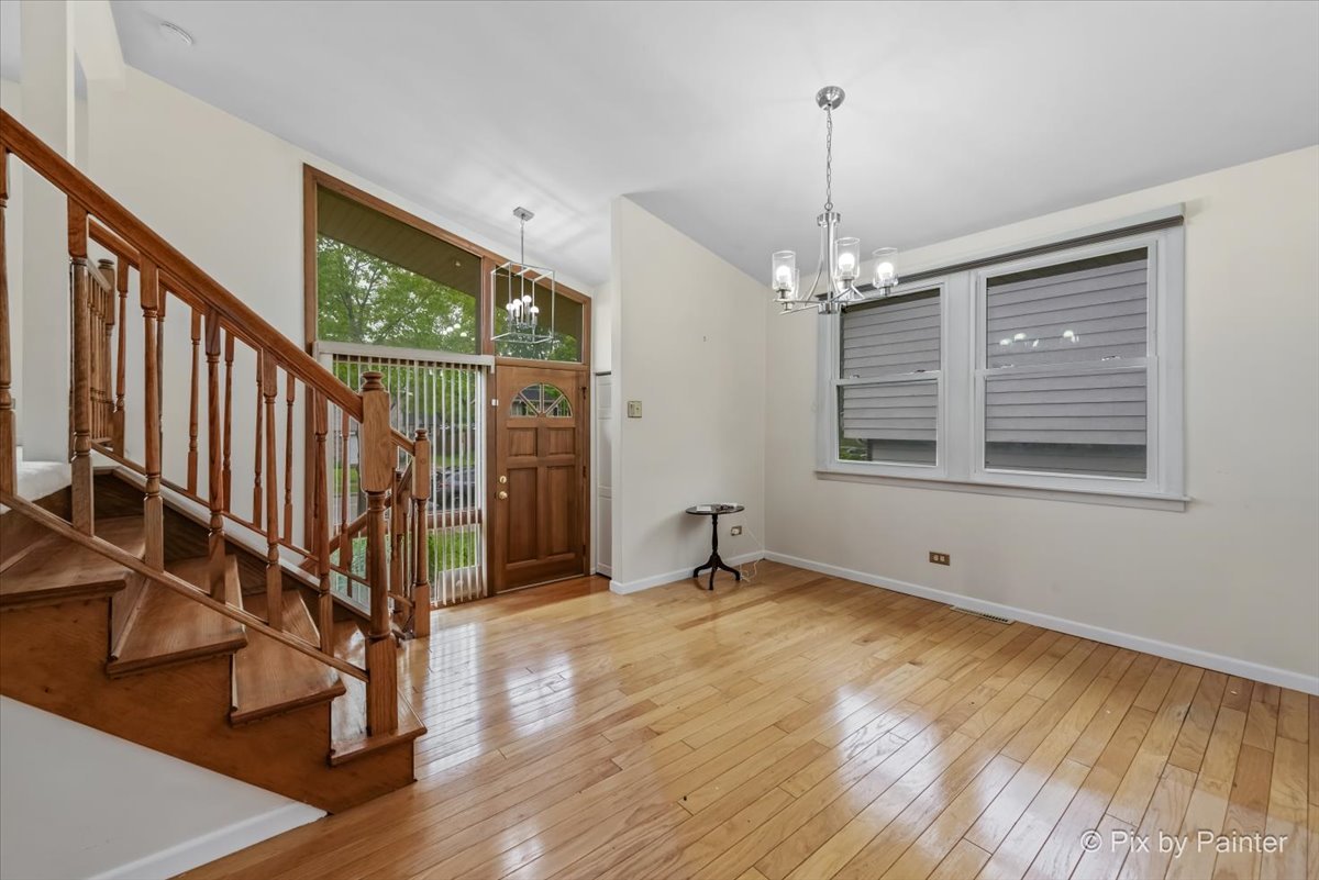 2302 Birch Lane Rolling Meadows, IL 60008 - Photo 6 of 30 a view of an empty room with wooden floor and a window