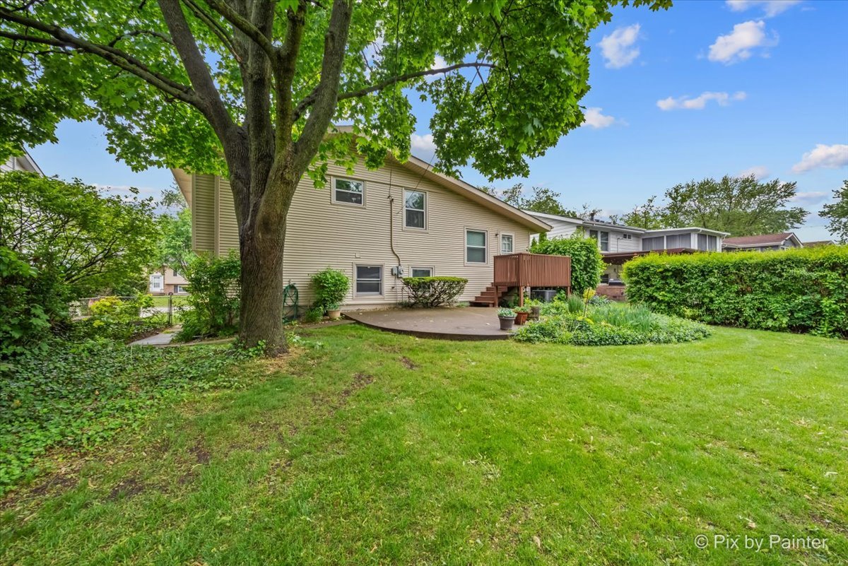 2302 Birch Lane Rolling Meadows, IL 60008 - Photo 7 of 30 a view of a backyard with table and chairs and a large tree