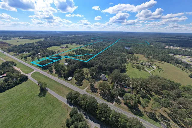 an aerial view of a house with a yard