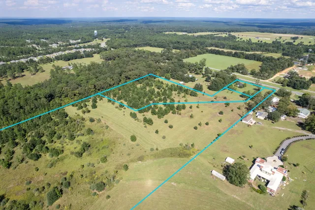 a view of a green field with an ocean view