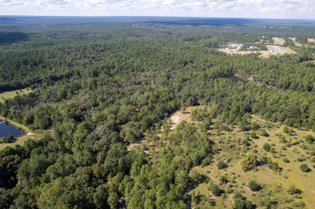 a view of a balcony with a yard