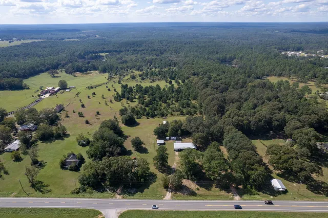 an aerial view of a house with a yard