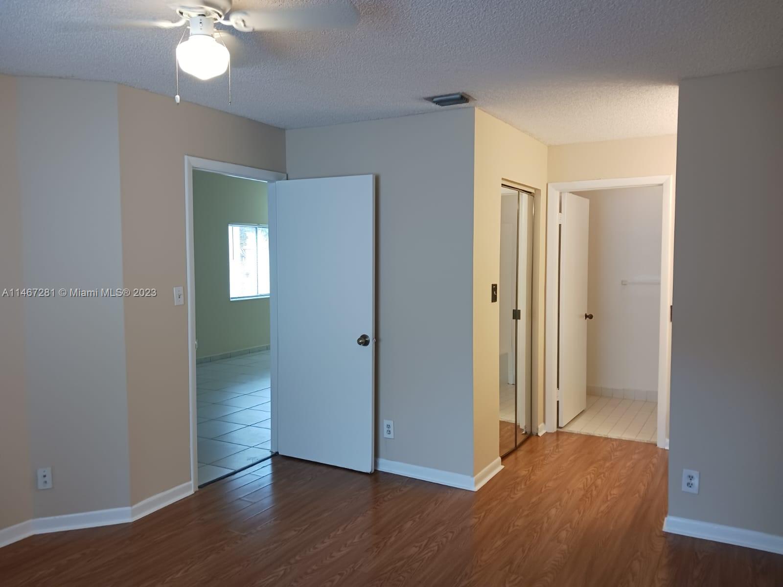 The Hammocks Miami, FL 33186 - Photo 13 of 17 a view of an empty room with wooden floor and a closet