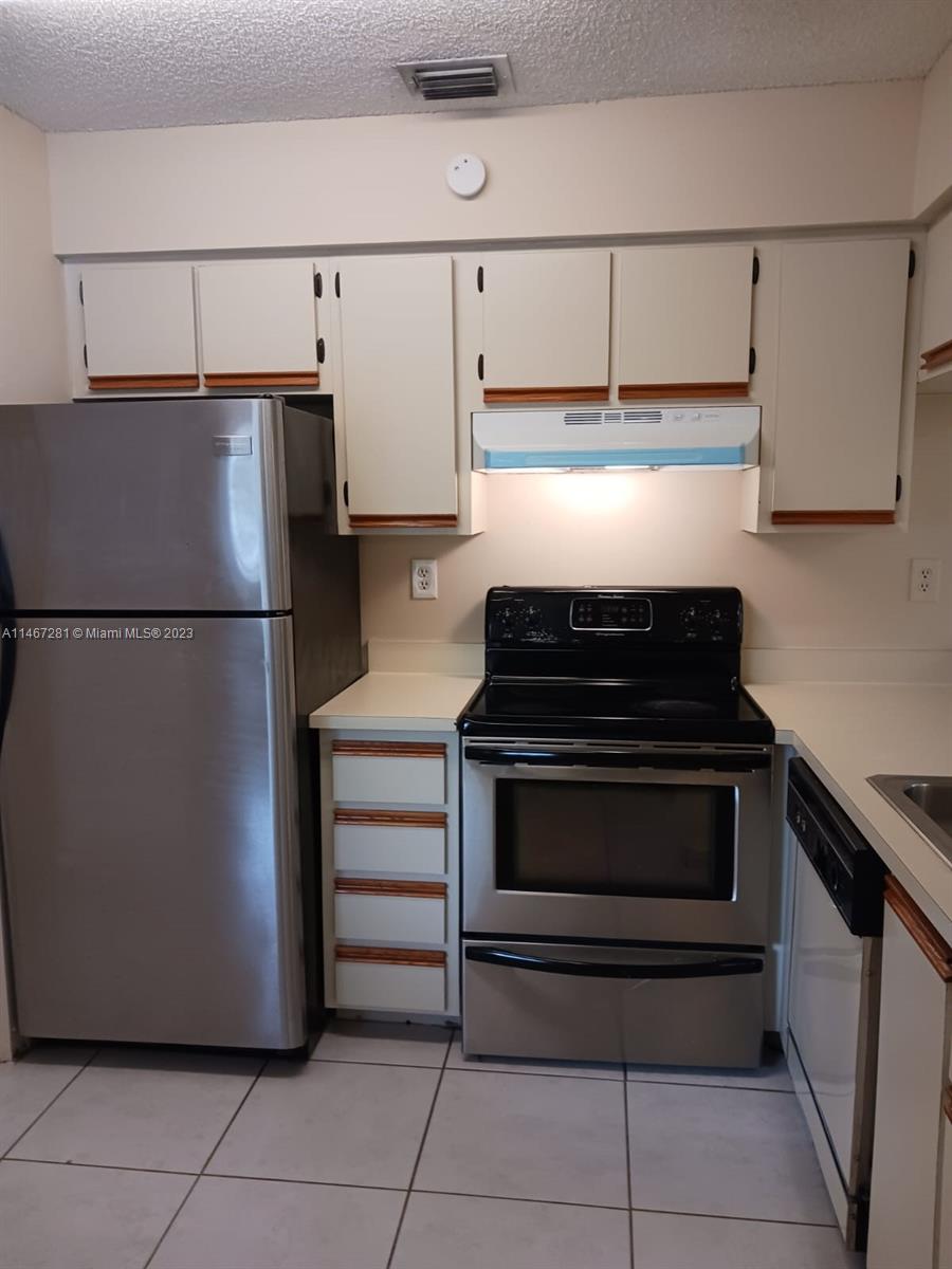 The Hammocks Miami, FL 33186 - Photo 9 of 17 a kitchen with a refrigerator and a stove