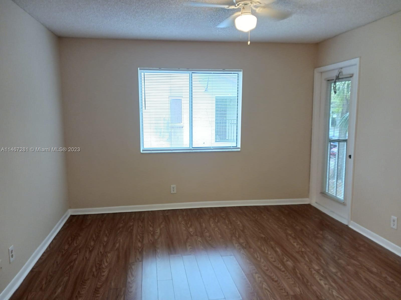 The Hammocks Miami, FL 33186 - Photo 10 of 17 an empty room with wooden floor and windows