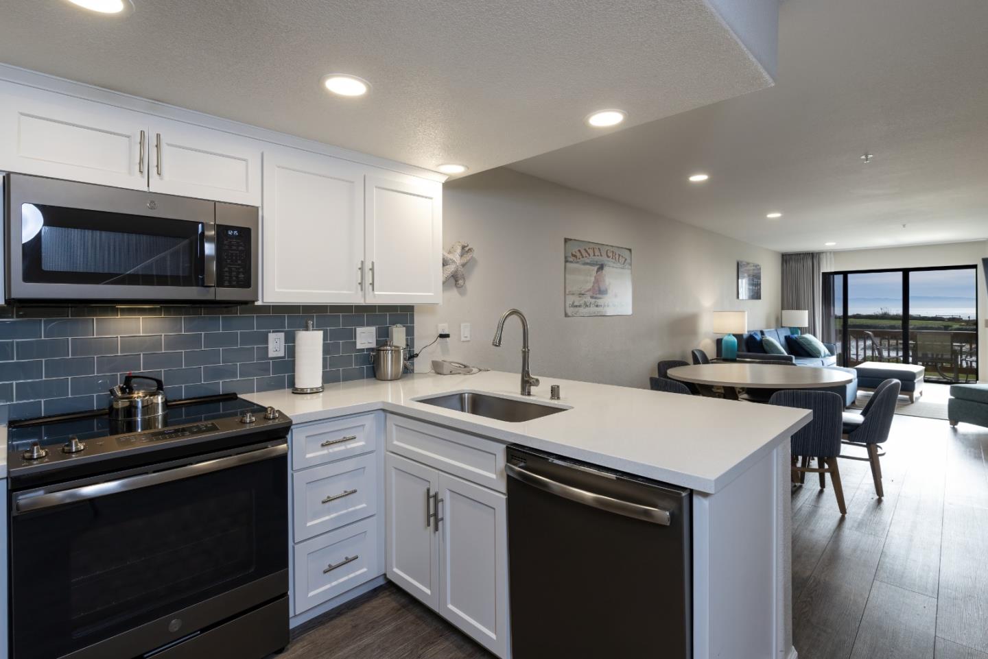443 Seascape Resort Drive Aptos, CA 95003 - Photo 12 of 33 a kitchen with stainless steel appliances a stove sink microwave refrigerator and cabinets
