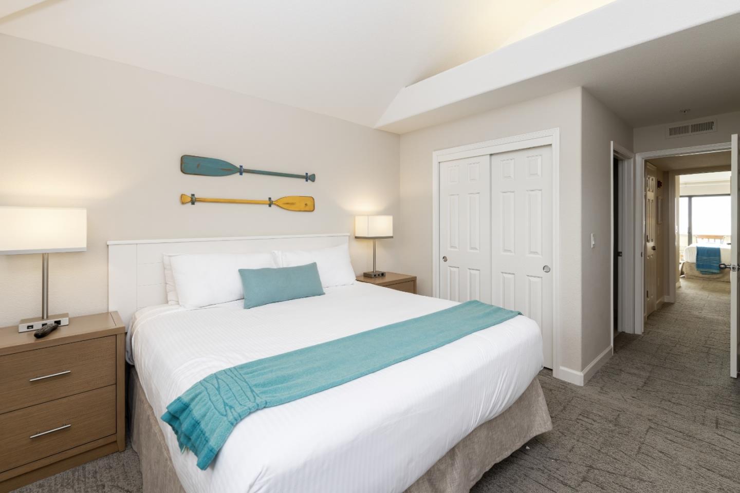 443 Seascape Resort Drive Aptos, CA 95003 - Photo 14 of 33 a bedroom with a bed and a lamp