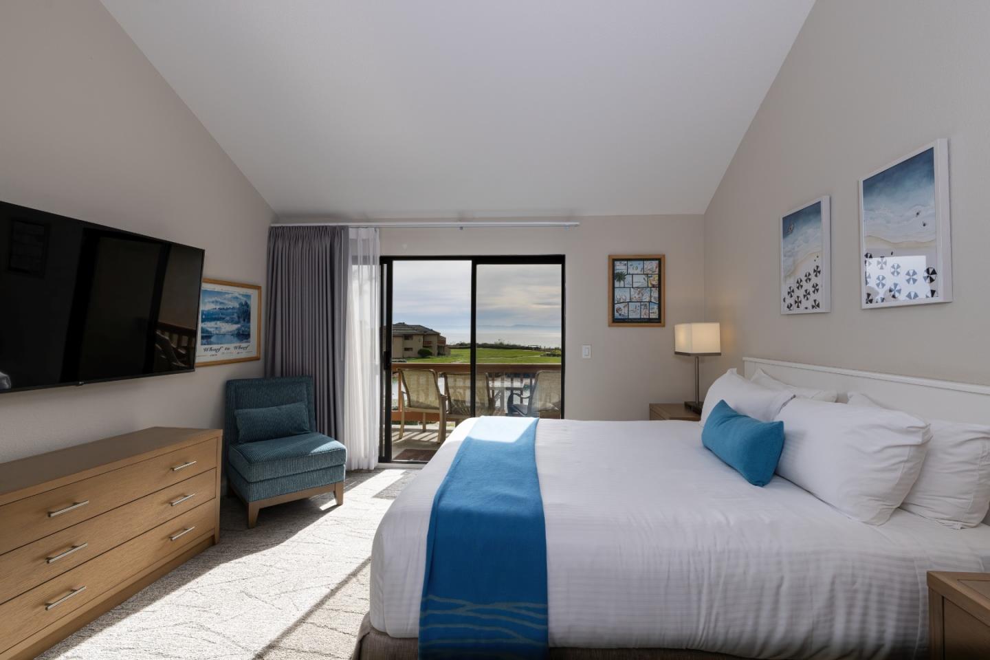 443 Seascape Resort Drive Aptos, CA 95003 - Photo 3 of 33 a bedroom with a large bed and a flat tv screen on dresser