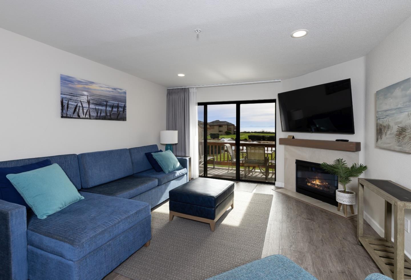 443 Seascape Resort Drive Aptos, CA 95003 - Photo 7 of 33 a living room with furniture a fireplace and a flat screen tv