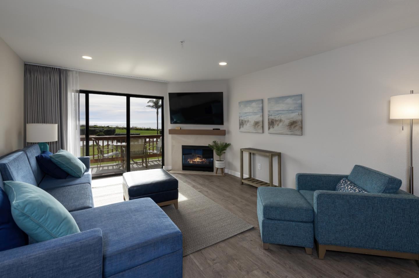 443 Seascape Resort Drive Aptos, CA 95003 - Photo 8 of 33 a living room with furniture a flat screen tv and a fireplace