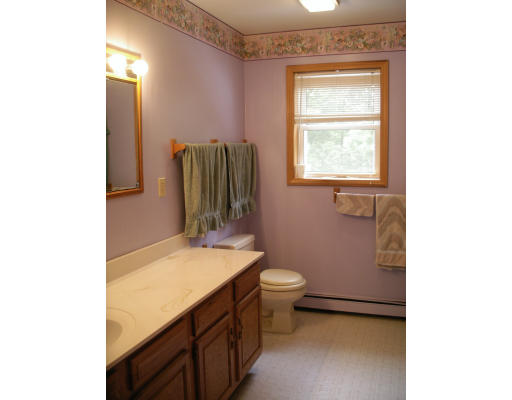 69 Brickyard Road Southampton, MA 01073 - Photo 8 of 10 a bathroom with a sink a toilet and mirror