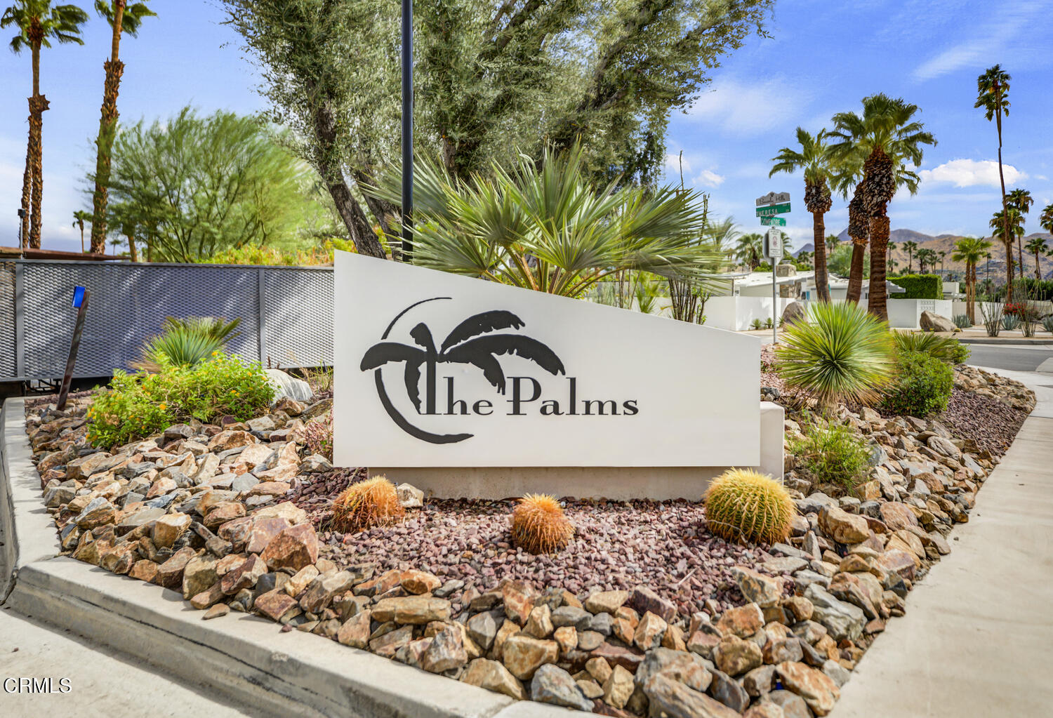 3155 Ramon Road, Unit 303 Palm Springs, CA 92264 - Photo 1 of 36 a sign that is in front of flowers