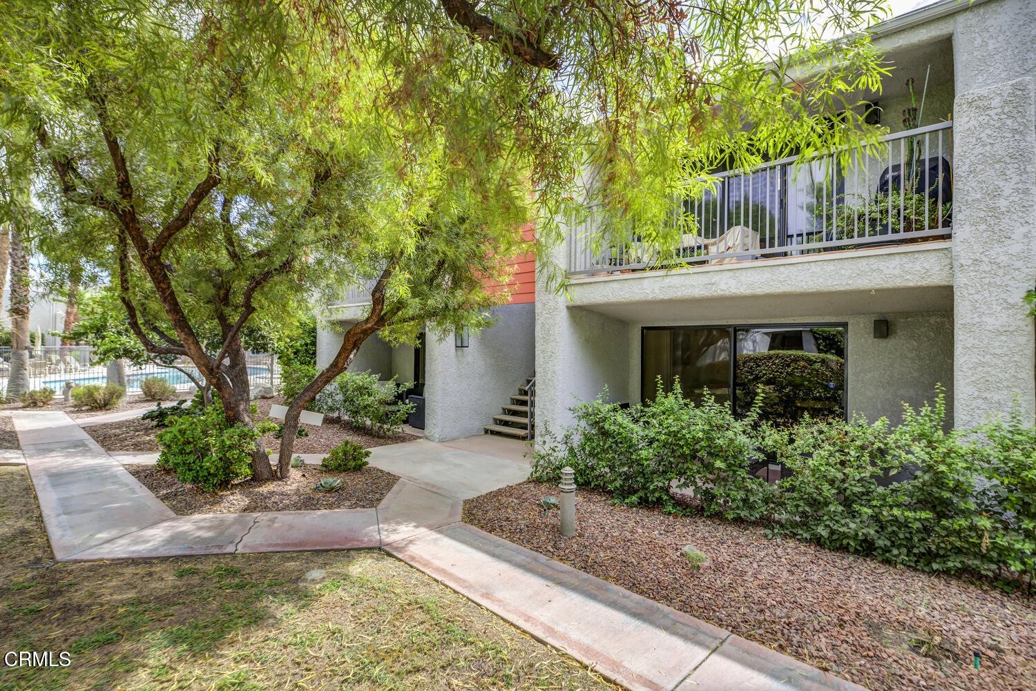 3155 Ramon Road, Unit 303 Palm Springs, CA 92264 - Photo 3 of 36 a front view of a house with garden