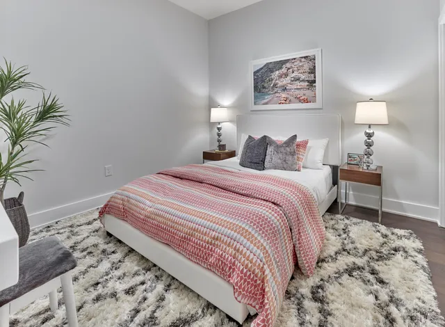 a bedroom with a bed and a potted plant