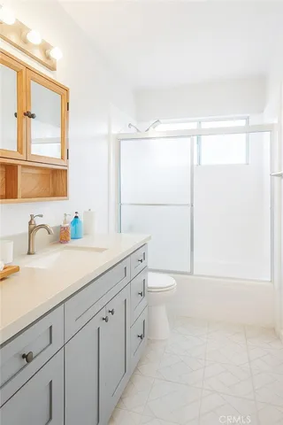 a bathroom with a granite countertop sink mirror and a