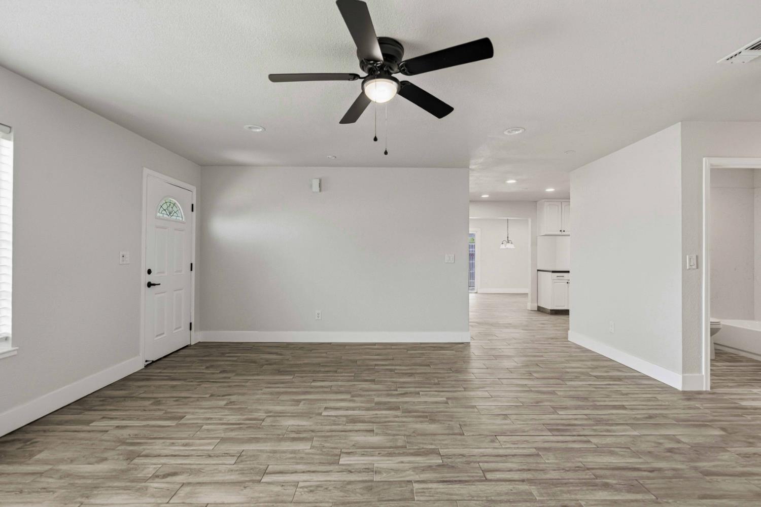 1464 Denise Drive Ripon, CA 95366 - Photo 6 of 41 a view of empty room with wooden floor and ceiling fan
