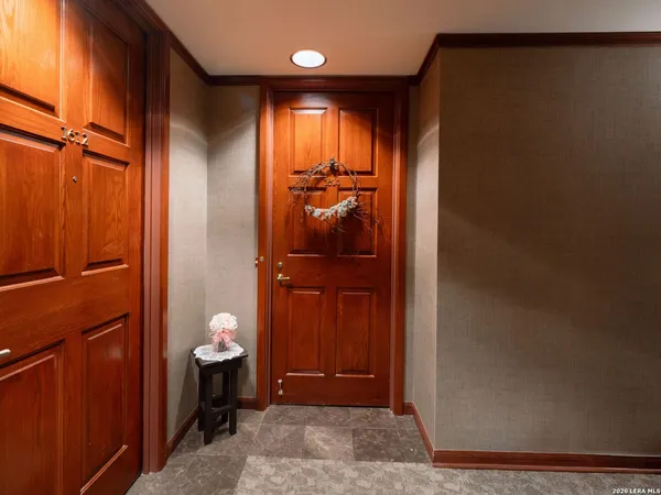 a view of a hallway with wooden floor and windows