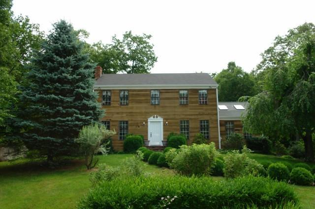 245 Thunder Lake Road Wilton, CT 06897 - Photo 1 of 1 a front view of a house with a yard and trees