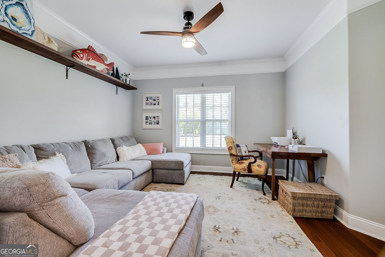 7272 Shellman Bluff Road Northeast, Unit 18 Townsend, GA 31331 - Photo 23 of 31 a living room with furniture a window and a chandelier