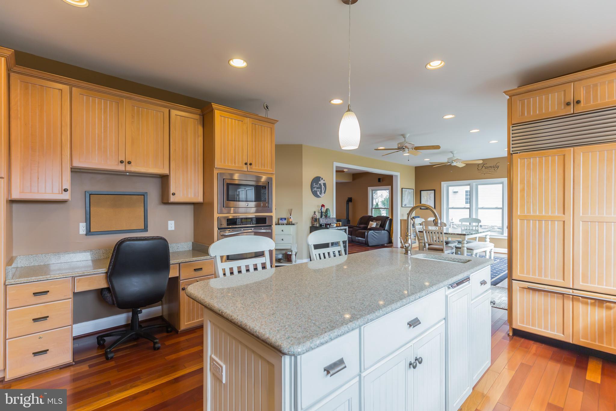 1457 Nieman Road Shady Side, MD 20764 - Photo 10 of 49 a kitchen with kitchen island granite countertop a sink cabinets and wooden floor