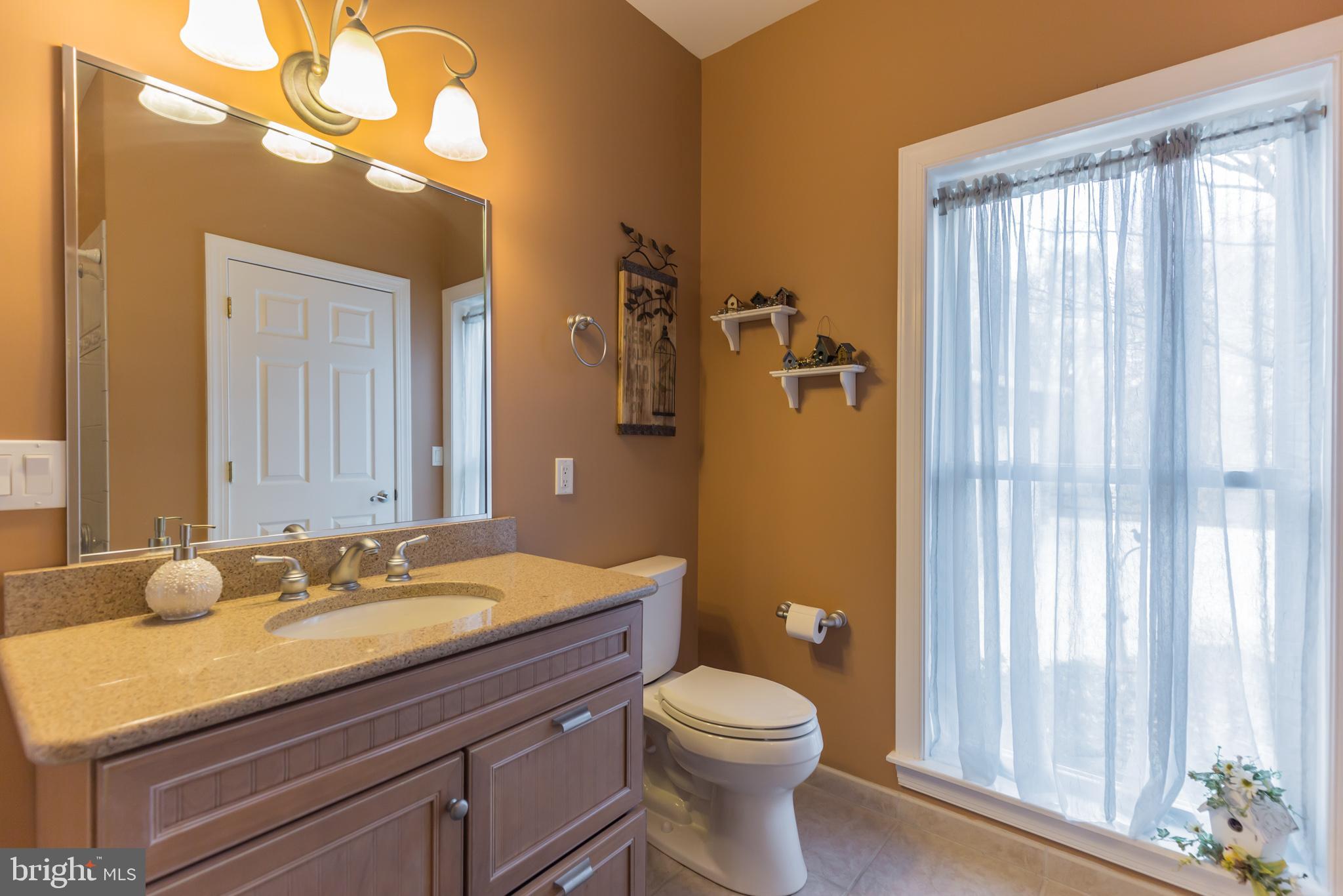 1457 Nieman Road Shady Side, MD 20764 - Photo 20 of 49 a bathroom with a granite countertop sink toilet and shower curtains
