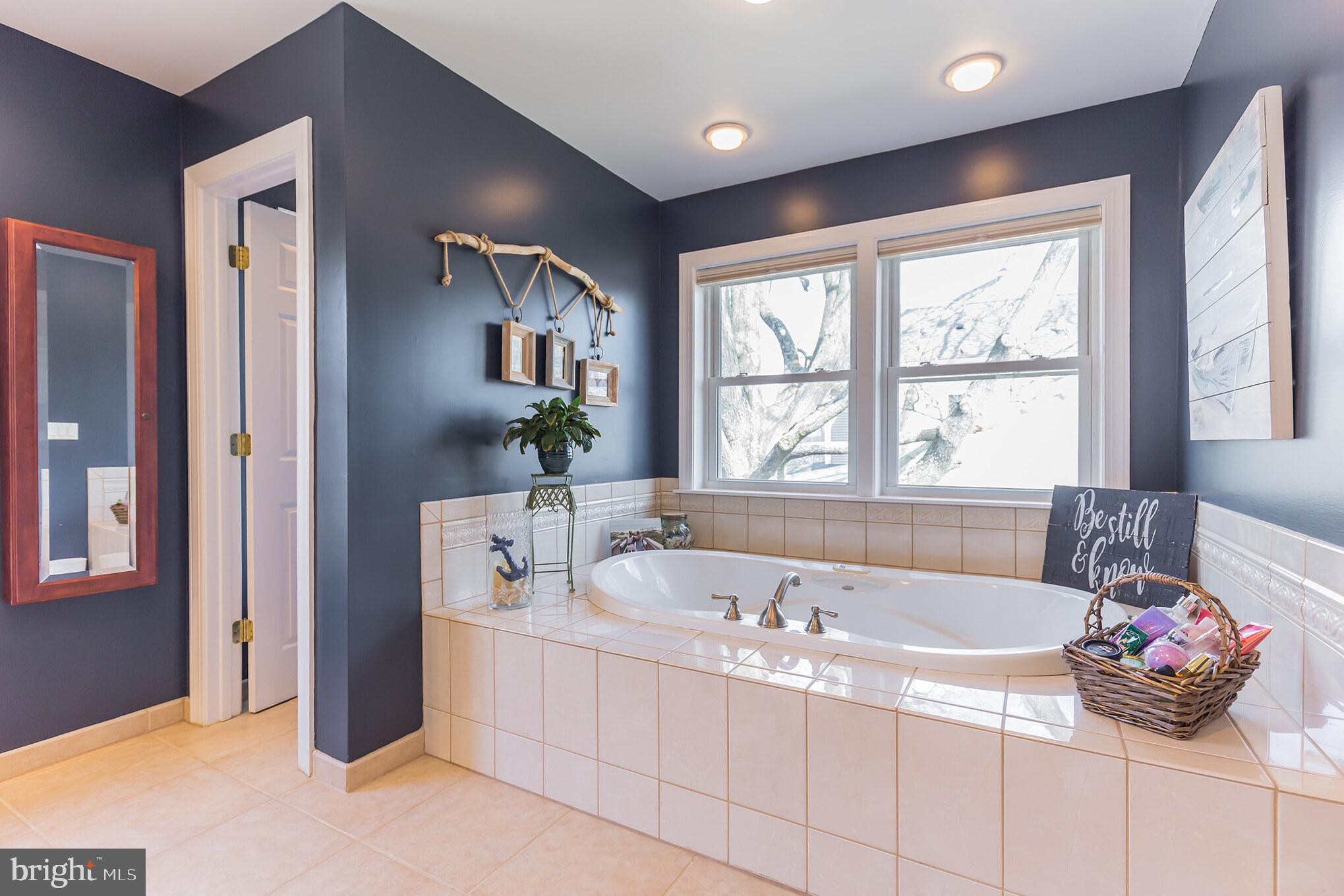 1457 Nieman Road Shady Side, MD 20764 - Photo 25 of 49 a bath tub sitting in a bathroom next to a window