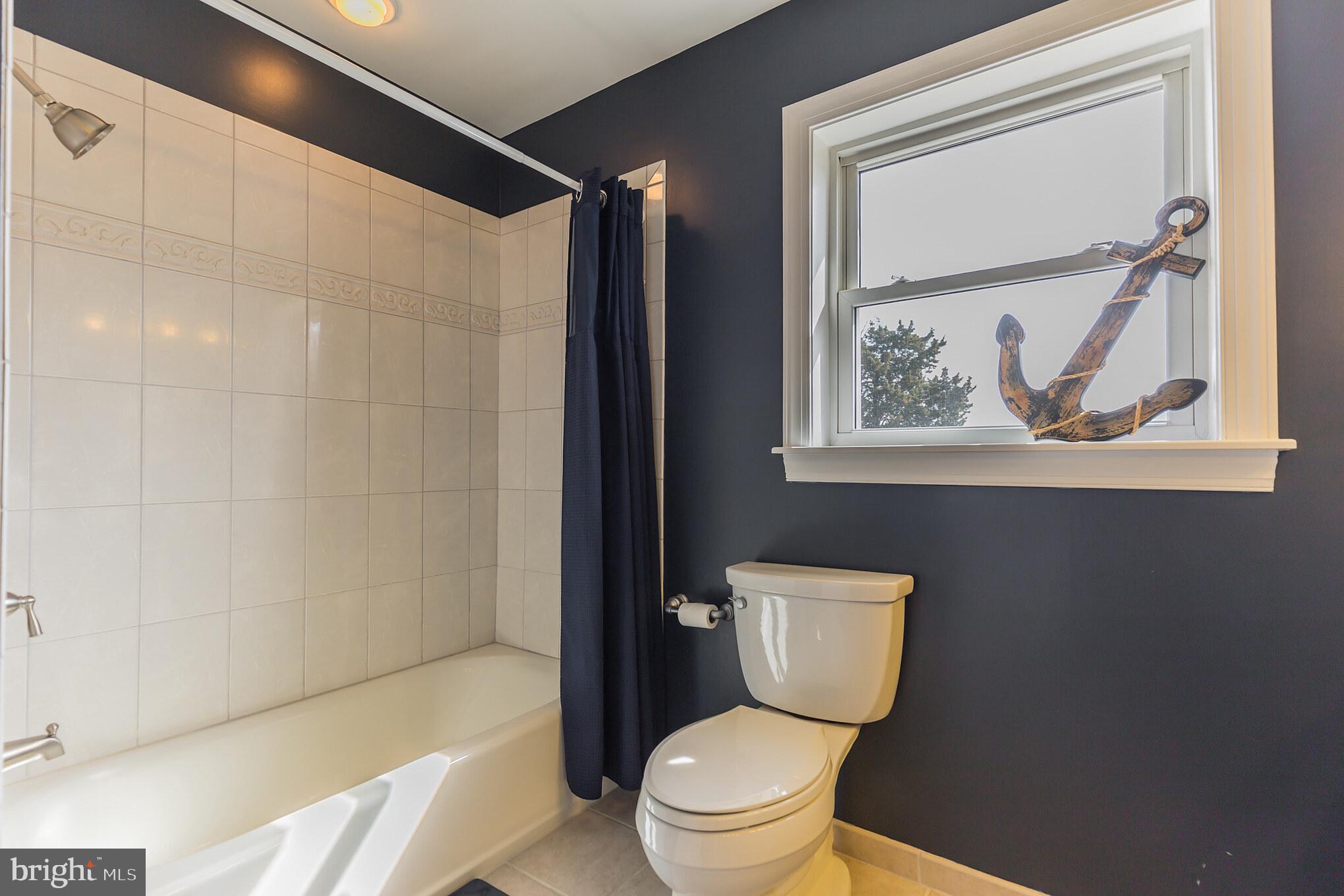 1457 Nieman Road Shady Side, MD 20764 - Photo 30 of 49 a white toilet sitting next to a bathroom sink and tub