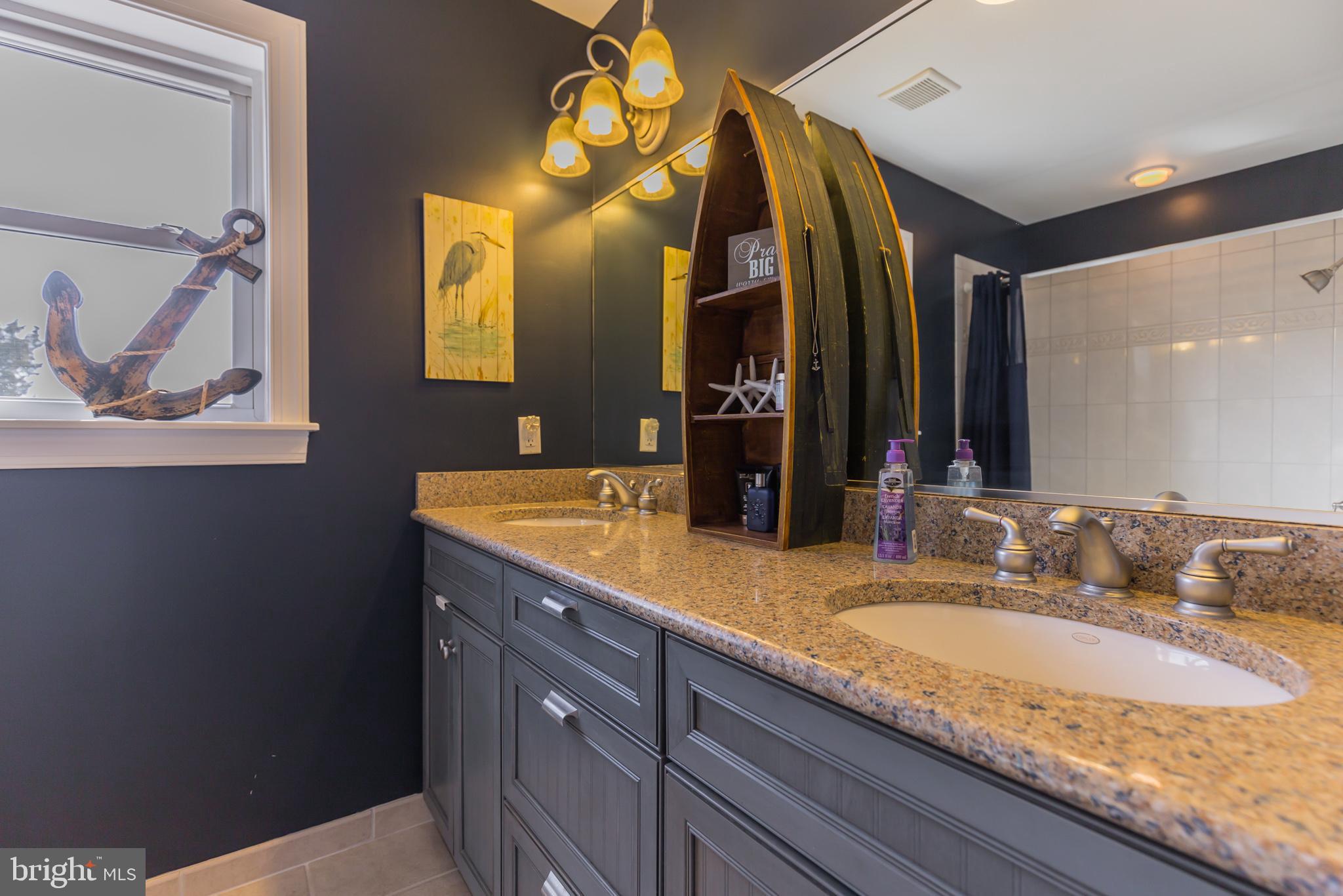 1457 Nieman Road Shady Side, MD 20764 - Photo 31 of 49 a bathroom with a granite countertop sink and a mirror