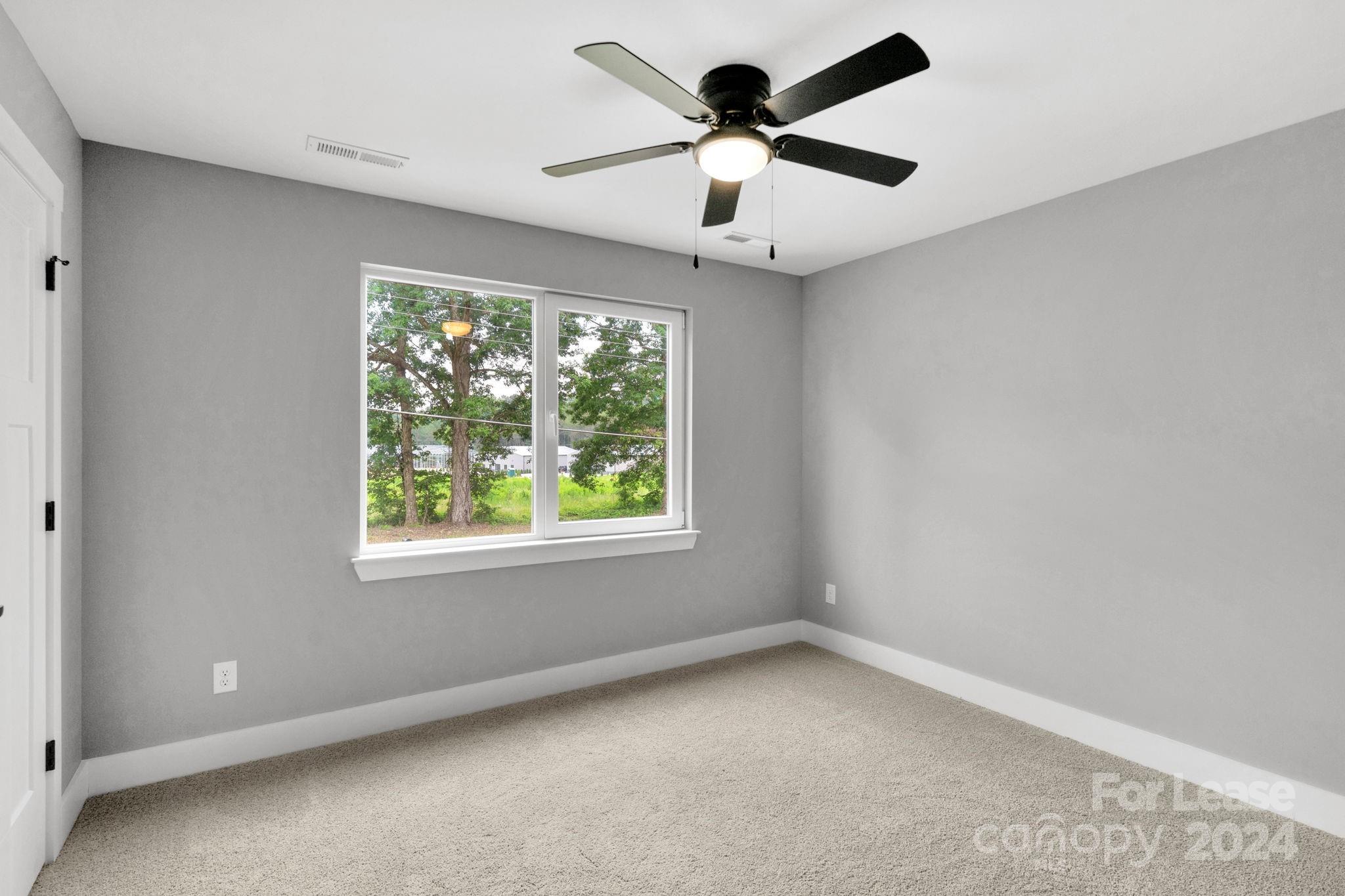 1112 Petes Road Lincolnton, NC 28092 - Photo 14 of 21 an empty room with a window and a fan