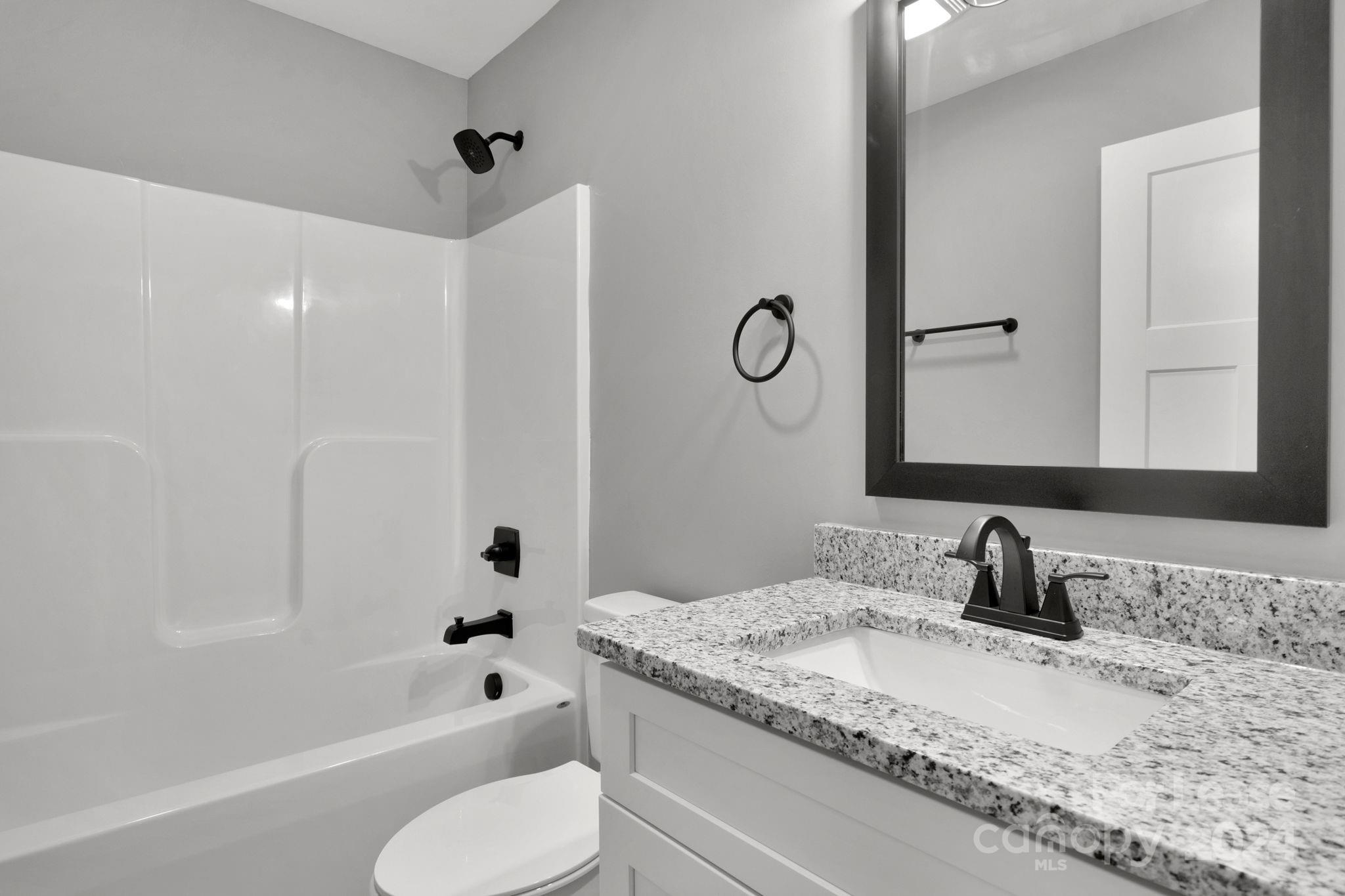 1112 Petes Road Lincolnton, NC 28092 - Photo 15 of 21 a bathroom with a granite countertop sink toilet and shower