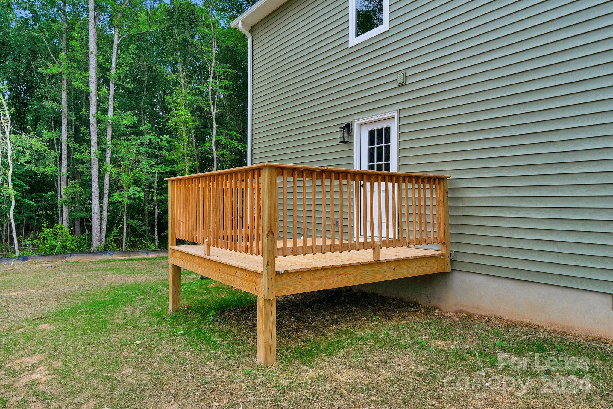 1112 Petes Road Lincolnton, NC 28092 - Photo 20 of 21 a view of a yard with a house and a wooden deck