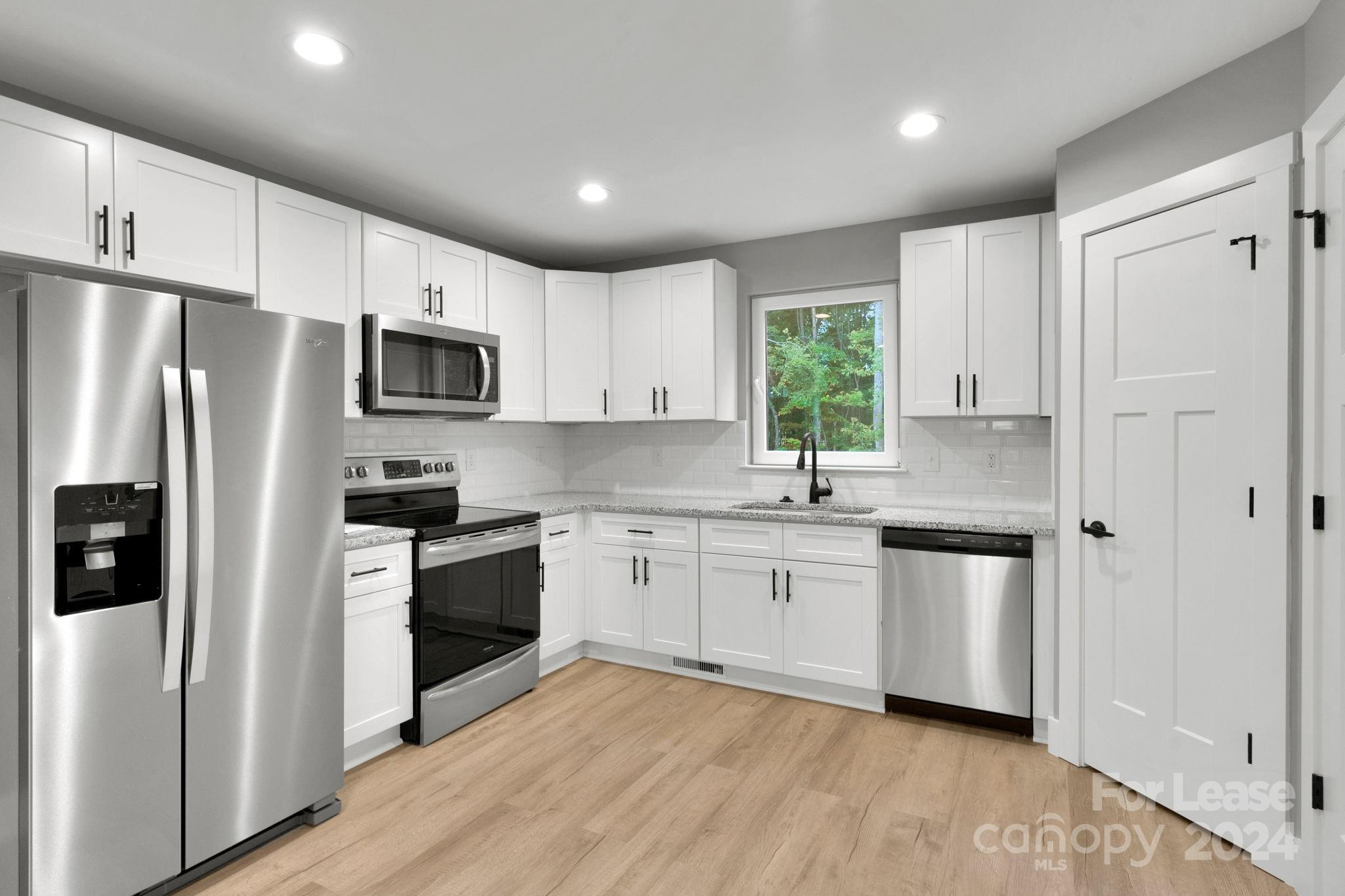 1112 Petes Road Lincolnton, NC 28092 - Photo 3 of 21 a kitchen with granite countertop white cabinets and stainless steel appliances
