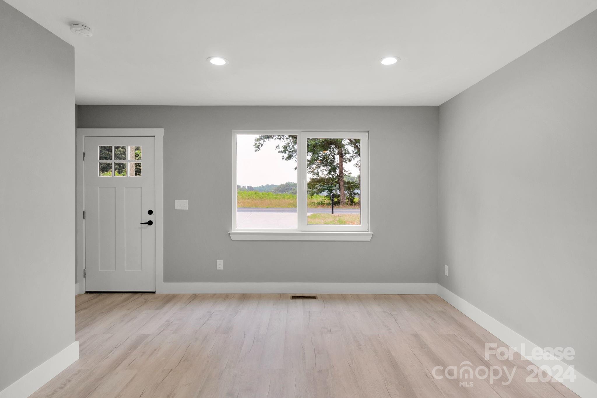 1112 Petes Road Lincolnton, NC 28092 - Photo 9 of 21 wooden floor in an empty room with a window