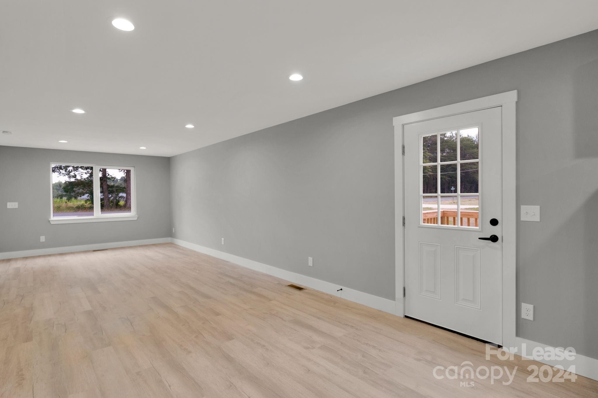 1112 Petes Road Lincolnton, NC 28092 - Photo 10 of 21 an empty room with wooden floor and windows