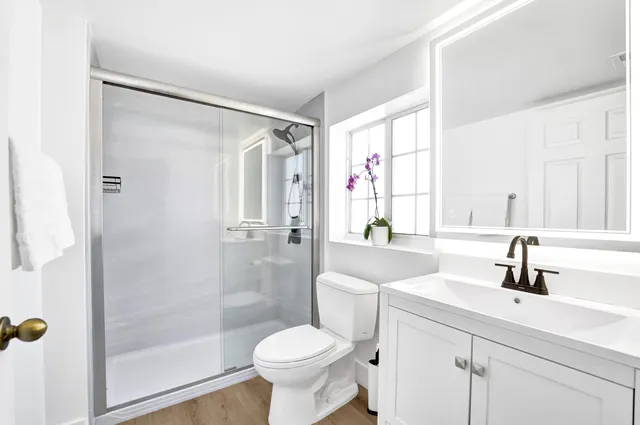 a bathroom with a sink toilet and shower