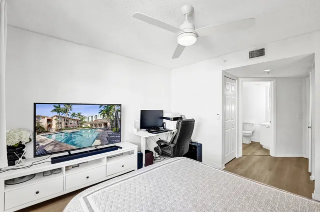 a view of a workspace with furniture and a flat screen tv