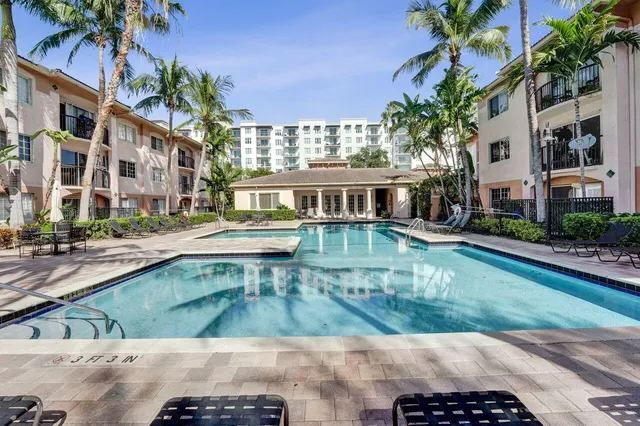 a view of a big building with a yard in the background