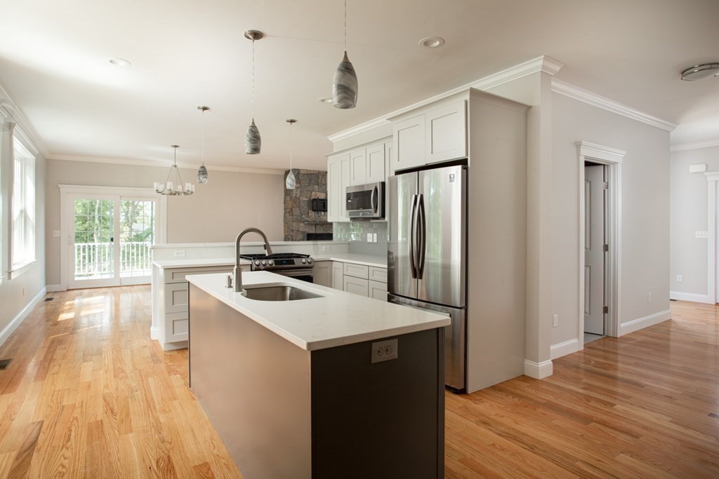 5 Julia Lane Assonet, MA 02702 - Photo 3 of 13 a kitchen with stainless steel appliances a sink a microwave a refrigerator and wooden floor