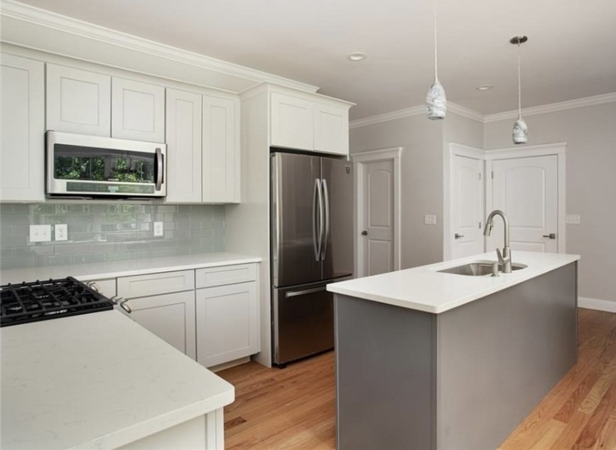 5 Julia Lane Assonet, MA 02702 - Photo 4 of 13 a kitchen with a sink a microwave a refrigerator and cabinets