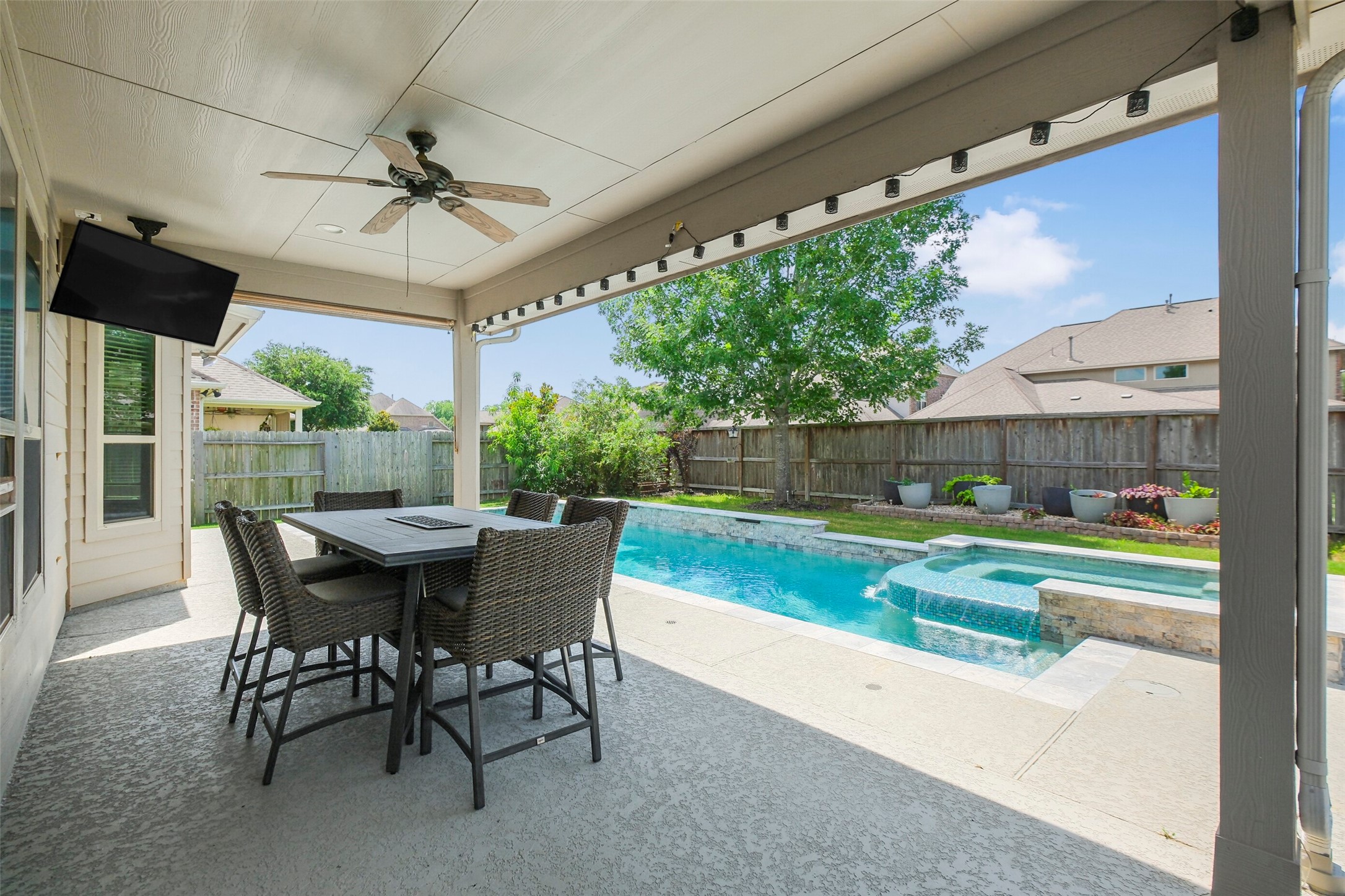30014 Valley Terrace Drive Fulshear, TX 77406 - Photo 31 of 36 Out back you will find the serene pool/spa, green space and covered patio with ceiling fan.