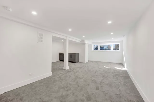 an empty room with a empty space and windows