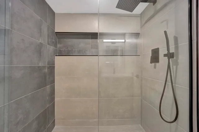 a bathroom with a glass shower door