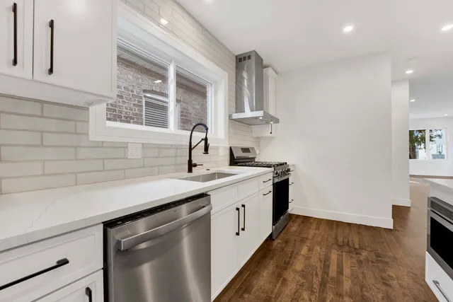 a kitchen with a sink stove and cabinets