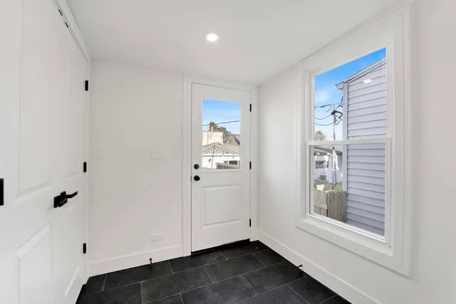 a view of an entryway with wooden floor