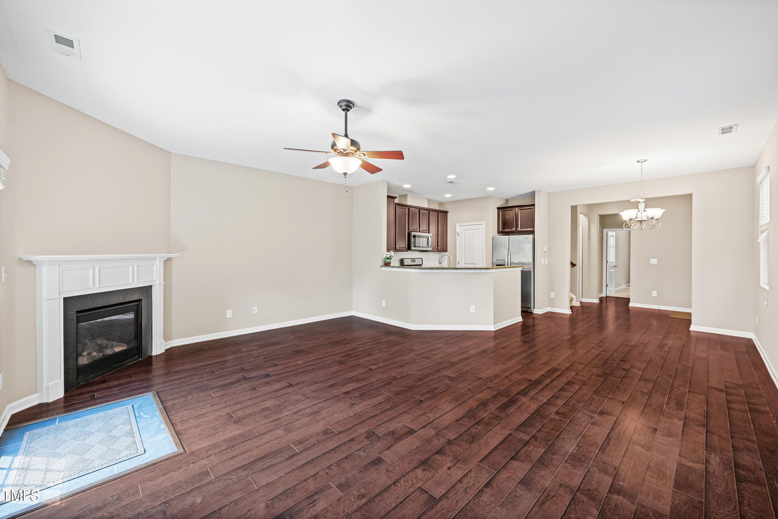 677 Wickham Ridge Road Apex, NC 27539 - Photo 11 of 34 a view of kitchen and hall with wooden floor
