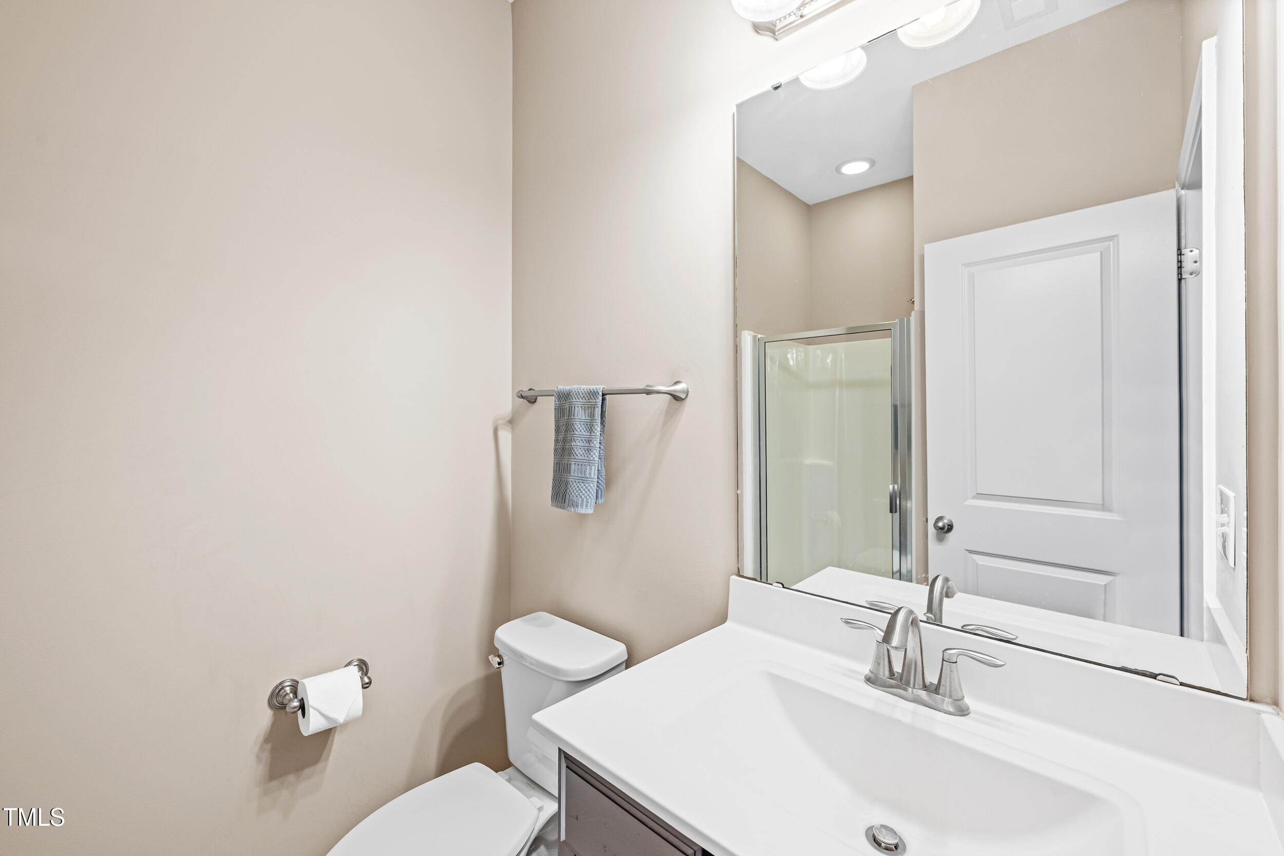 677 Wickham Ridge Road Apex, NC 27539 - Photo 16 of 34 a bathroom with a sink a toilet and a mirror
