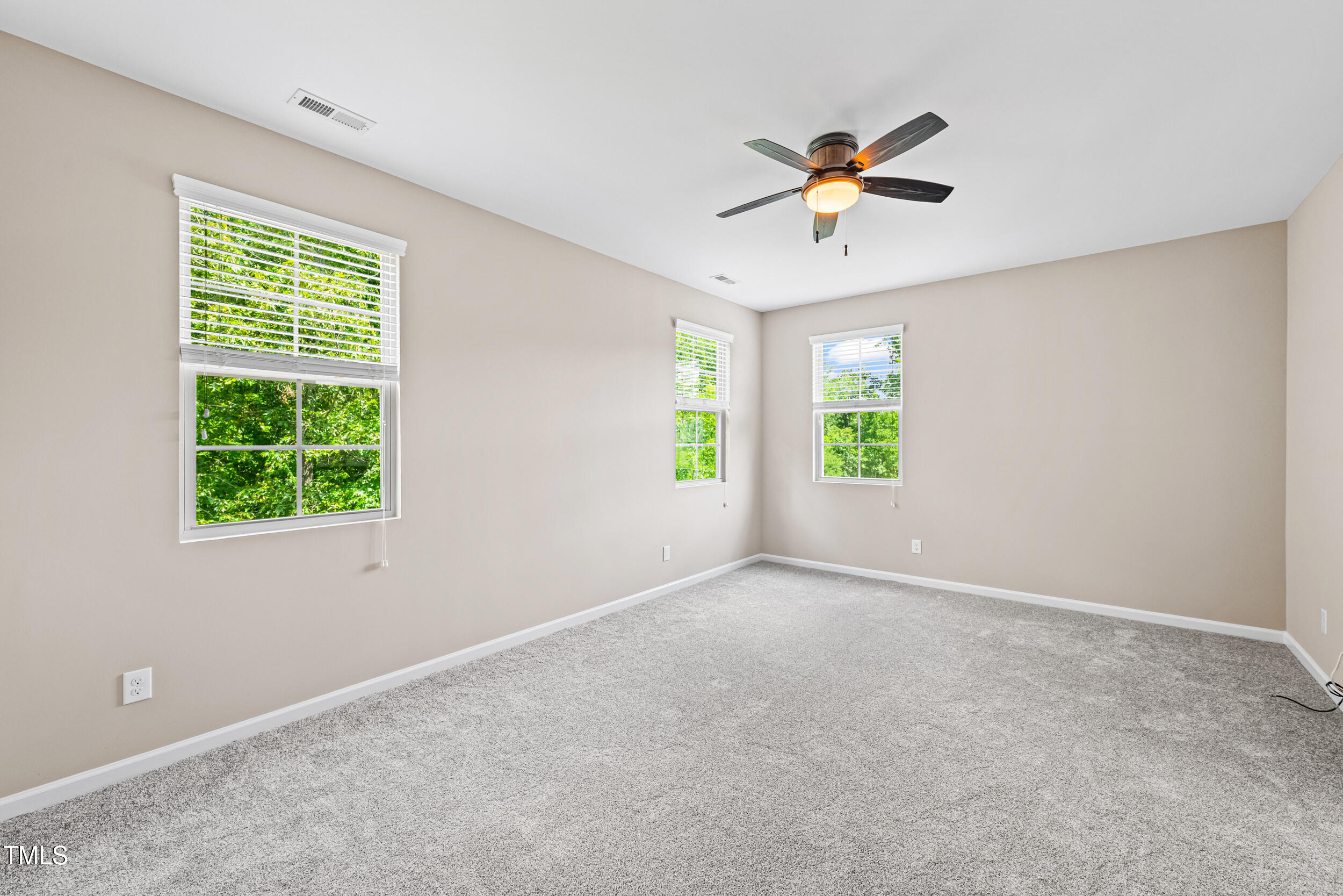 677 Wickham Ridge Road Apex, NC 27539 - Photo 21 of 34 a view of a livingroom with a window and a ceiling fan