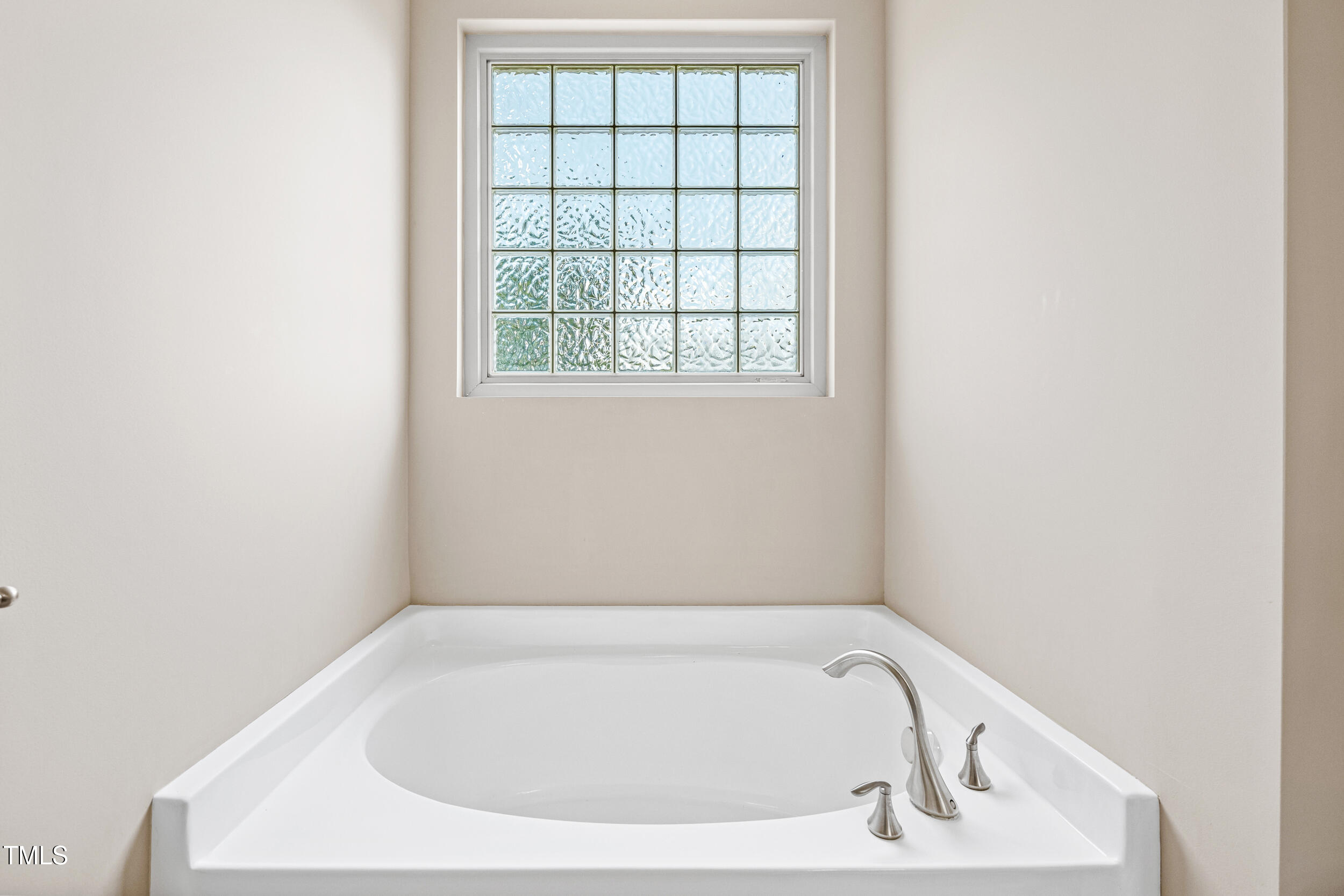 677 Wickham Ridge Road Apex, NC 27539 - Photo 24 of 34 a white bath tub sitting in a bathroom