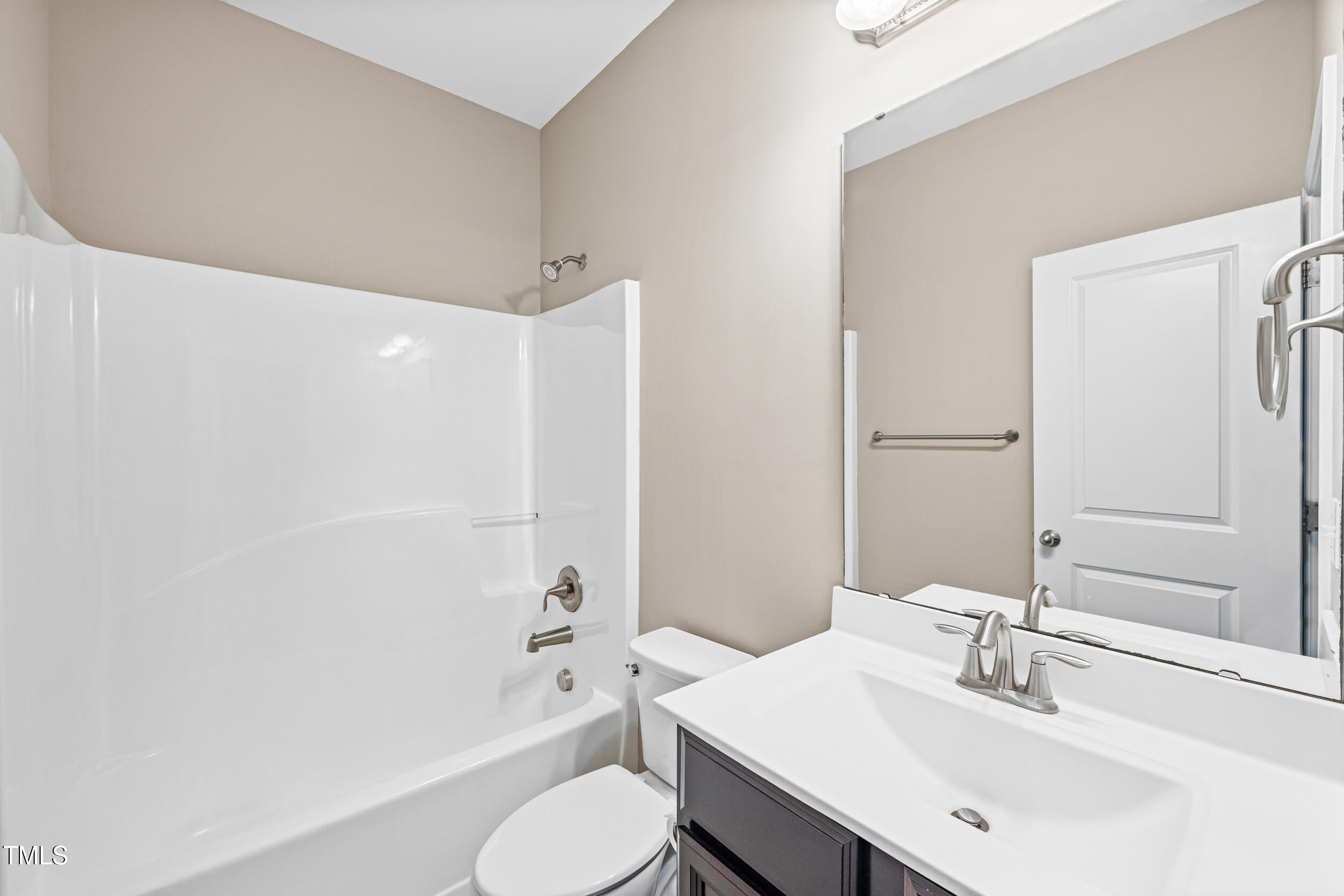 677 Wickham Ridge Road Apex, NC 27539 - Photo 28 of 34 a bathroom with a sink toilet and shower